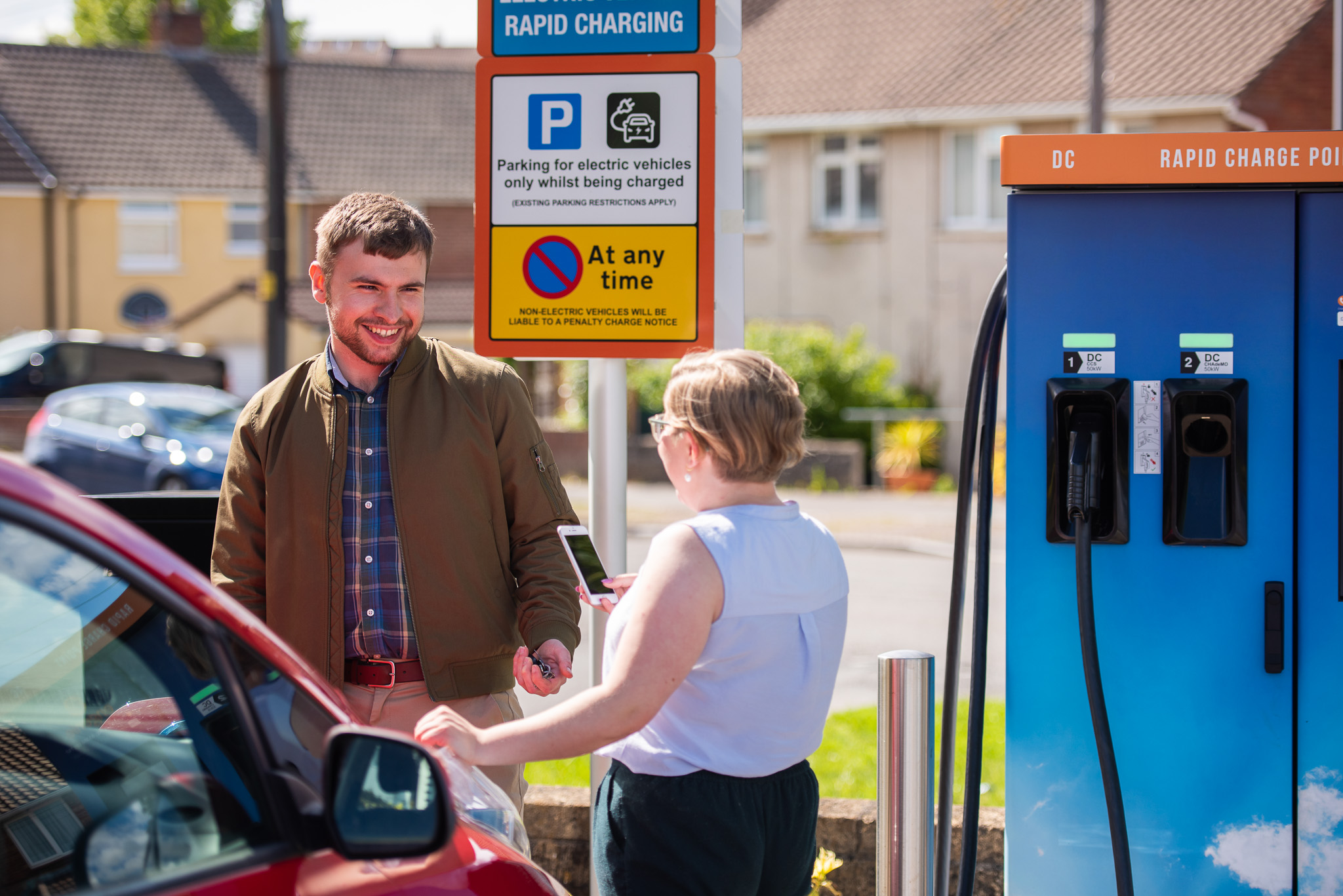 Joe and Isabel chat at an EV charging location