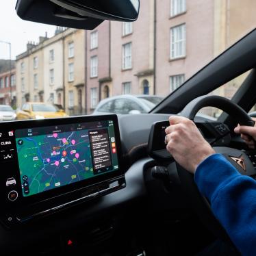 Someone driving with Zapmap's in-car app on the dashboard screen 