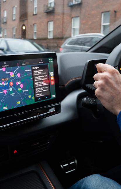 Someone driving with Zapmap's in-car app on the dashboard screen 