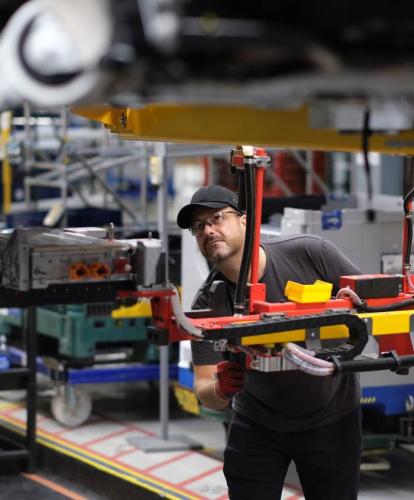 Man working in JLR factory surrounded by tools and equiptment
