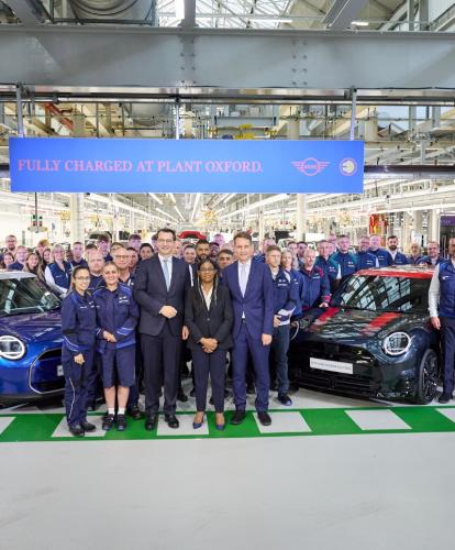 Workers gather around MINIs in Oxford plant