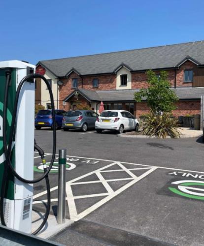 evyve charger in a car park in front of pub
