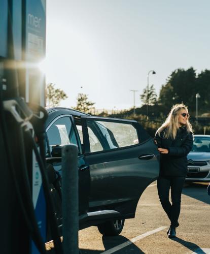 Couple charges EV at Mer charge point