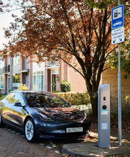 ubitricity on-street charge point charging EV under a tree