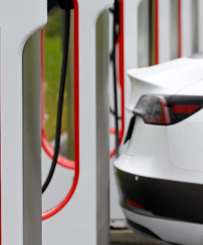 Tesla superchargers charging white Tesla