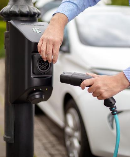 On-street char.gy bollard style charge point being plugged into a white Renault Zoe