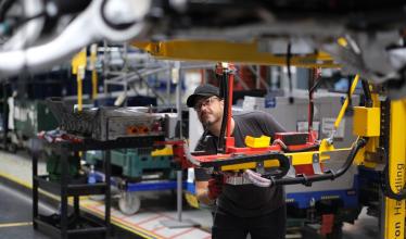 Man working in JLR factory surrounded by tools and equiptment