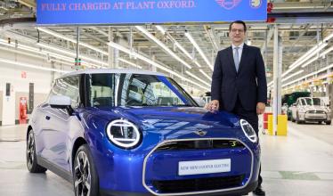 Dr Milan Nedeljkovi stands beside a blue mini inside the Oxford production plant