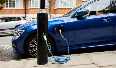 on-street lamp post charger charging a blue EV