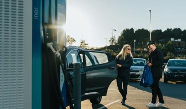 Couple charges EV at Mer charge point