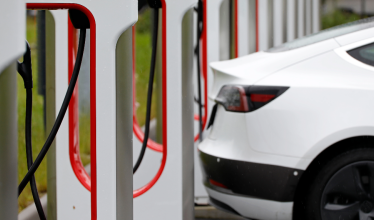 Tesla superchargers charging white Tesla
