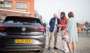 VW charging with 3 people looking at Zapmap app on phone