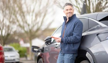 Man uses Zapmap app to check on status of EV charging 