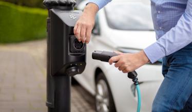 On-street char.gy bollard style charge point being plugged into a white Renault Zoe