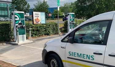 Siemens branded van parked in front of an Evyve charge point