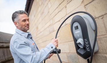 Man handling EV home charger